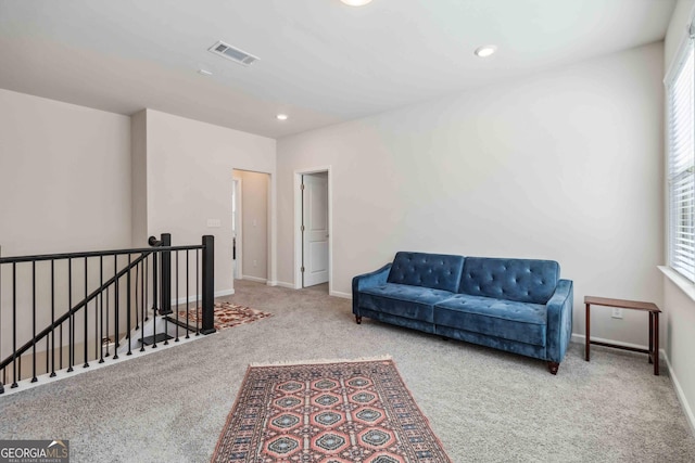 sitting room featuring an upstairs landing, carpet, baseboards, and recessed lighting