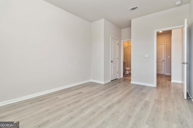 unfurnished bedroom featuring light wood-style flooring and baseboards