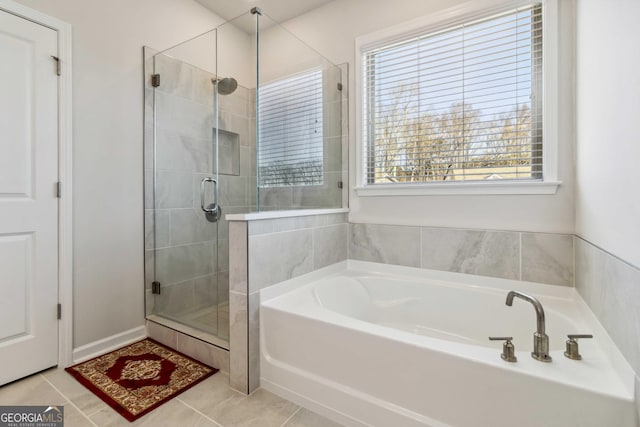 bathroom with a stall shower, plenty of natural light, a bath, and tile patterned flooring