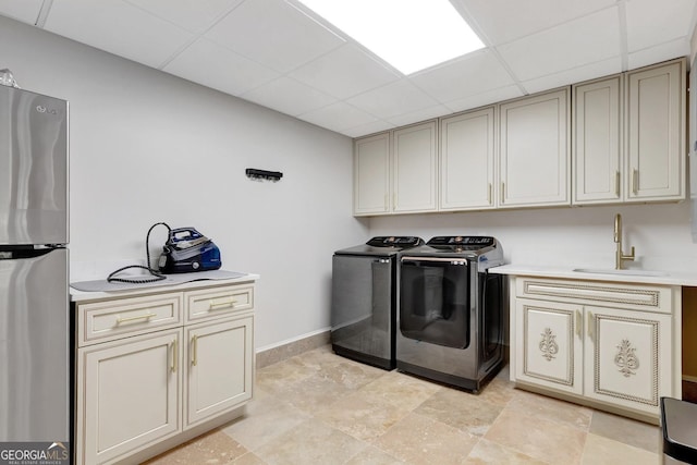 clothes washing area with sink and washing machine and clothes dryer