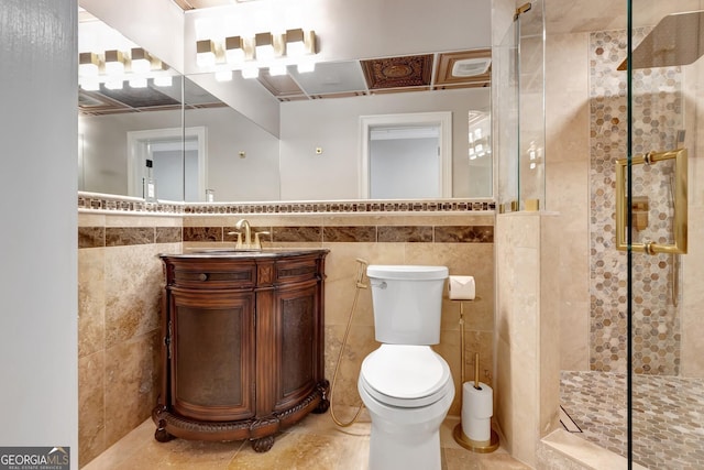 bathroom with vanity, tile walls, and a shower with door