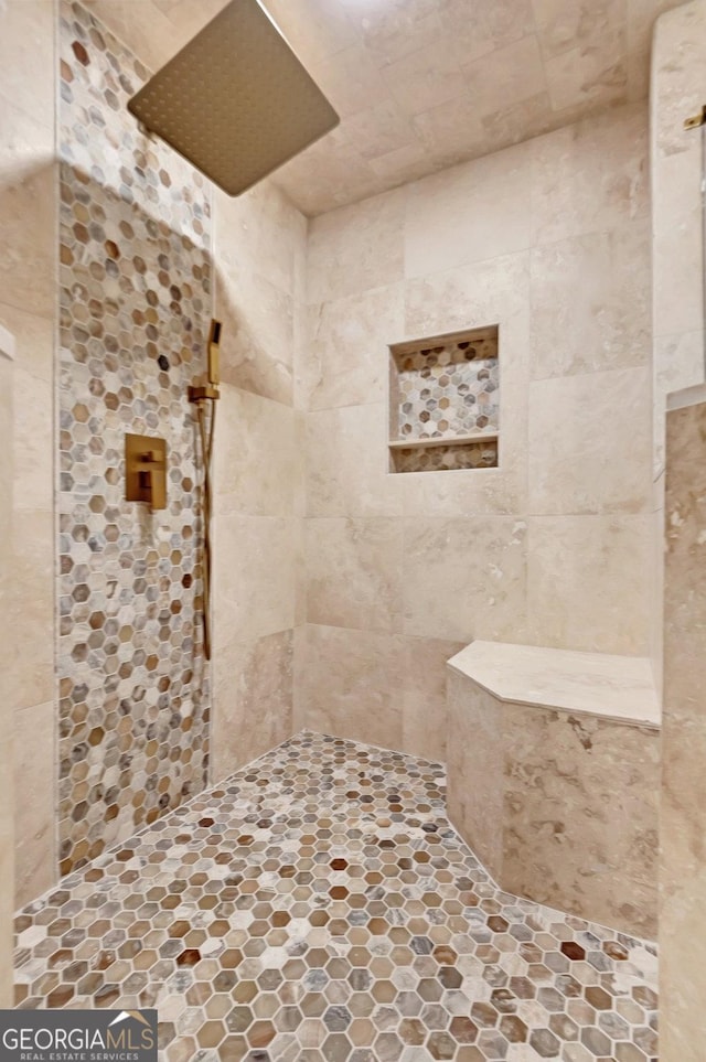 bathroom featuring a tile shower