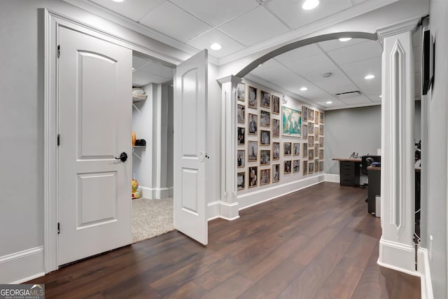 hallway with dark hardwood / wood-style flooring and a drop ceiling