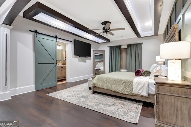 bedroom featuring ensuite bathroom, a barn door, ceiling fan, dark hardwood / wood-style flooring, and crown molding