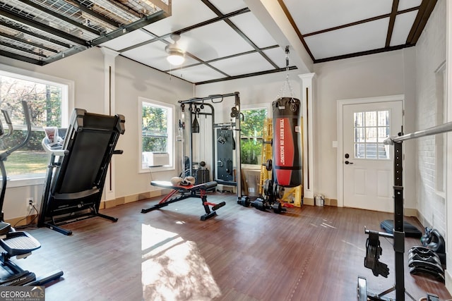 exercise area with ceiling fan, cooling unit, and hardwood / wood-style flooring