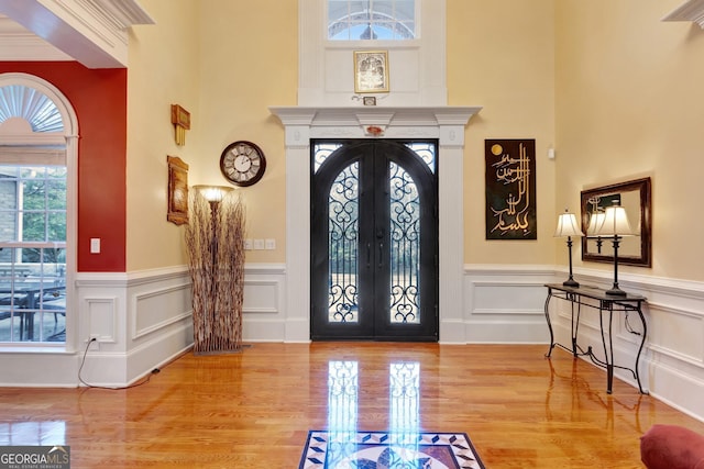 entrance foyer with light wood-type flooring and french doors