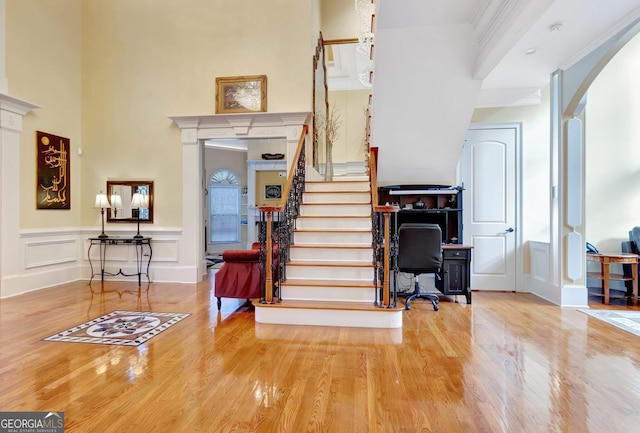 stairs featuring crown molding and hardwood / wood-style flooring