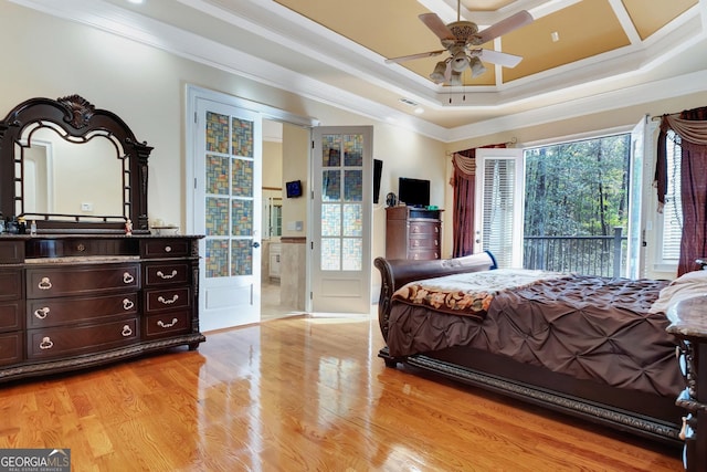 bedroom with ceiling fan, access to exterior, crown molding, and a tray ceiling