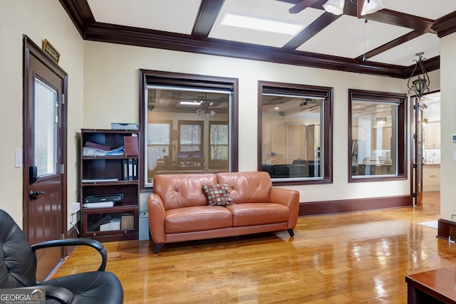 living room with crown molding, light hardwood / wood-style floors, and coffered ceiling