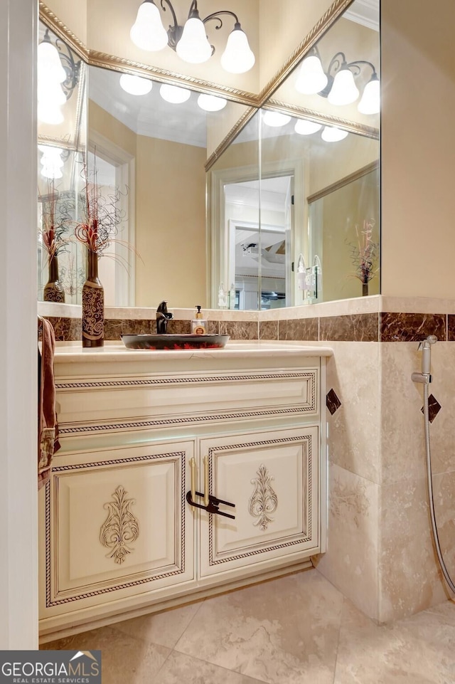 bathroom featuring walk in shower, vanity, and tile walls