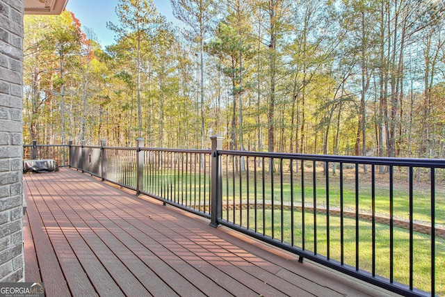 wooden deck with a lawn