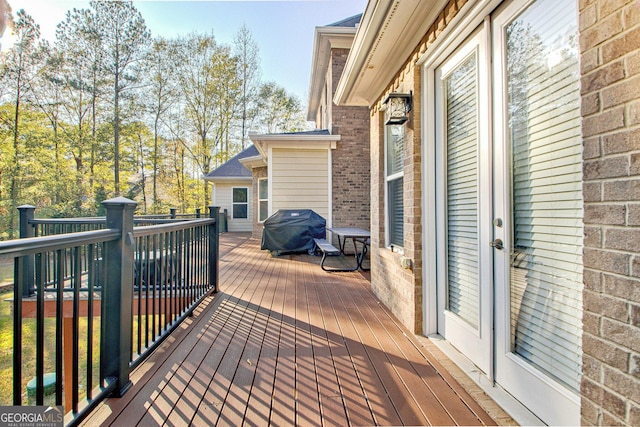 wooden deck featuring a grill