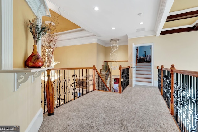 hall featuring carpet, crown molding, and an inviting chandelier