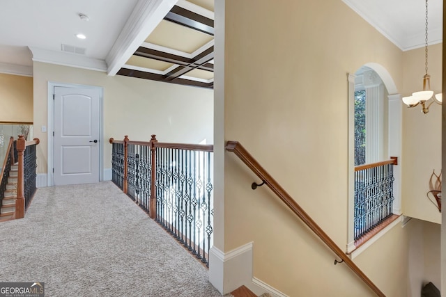 hall featuring beam ceiling, crown molding, coffered ceiling, and carpet flooring