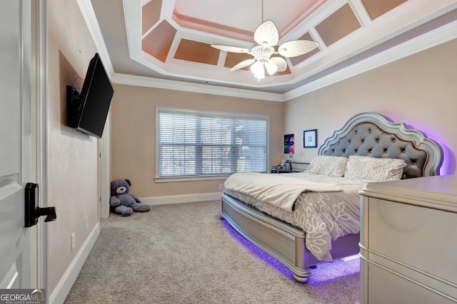 bedroom with ceiling fan, a tray ceiling, crown molding, coffered ceiling, and carpet flooring