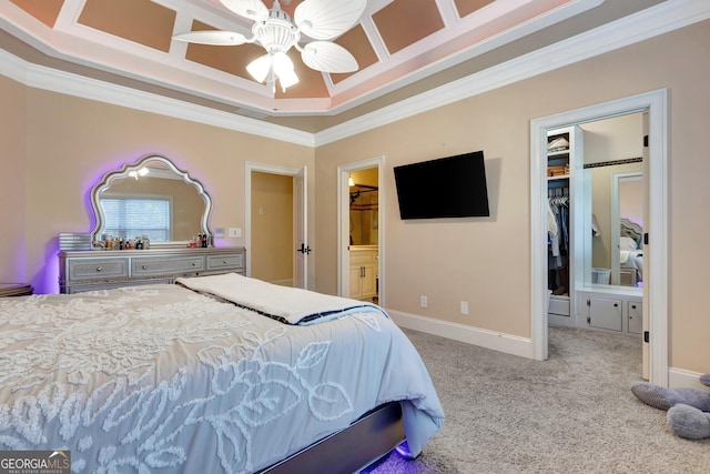 bedroom featuring ceiling fan, carpet, ensuite bathroom, a raised ceiling, and ornamental molding