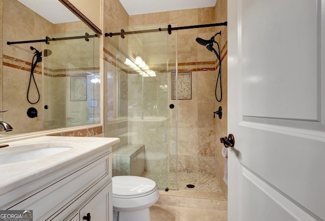 bathroom with toilet, a shower with shower door, and vanity