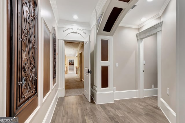 corridor with crown molding and light hardwood / wood-style floors