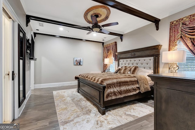 bedroom with ceiling fan, dark wood-type flooring, crown molding, and beamed ceiling