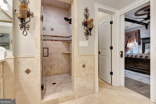 bathroom featuring an enclosed shower, tile walls, and tile patterned flooring