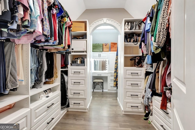 spacious closet featuring wood-type flooring and lofted ceiling