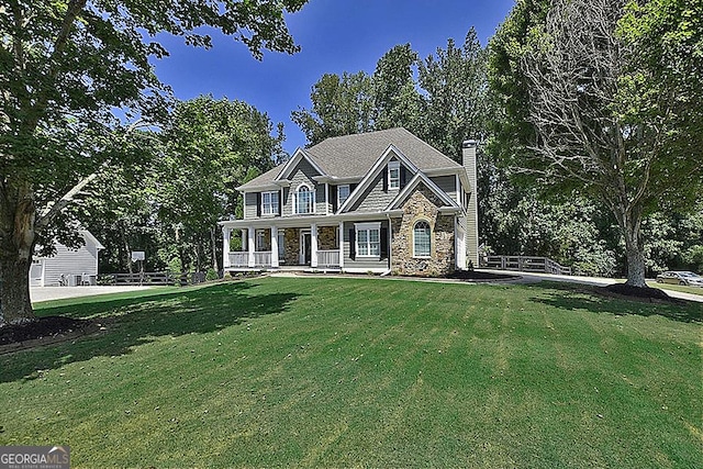 view of front of home with a front yard and covered porch