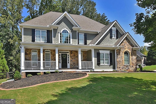 view of front facade with covered porch and a front yard