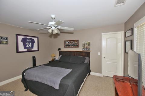 carpeted bedroom with ceiling fan