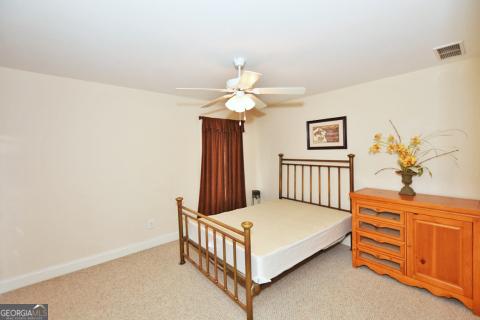 carpeted bedroom with ceiling fan