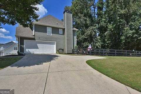 view of side of home featuring a garage and a lawn