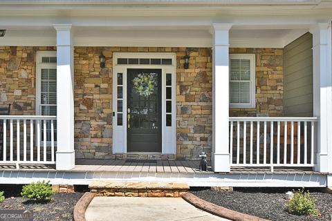 view of exterior entry with covered porch