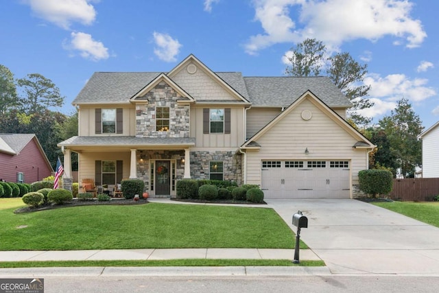 craftsman inspired home featuring a front yard, a porch, and a garage