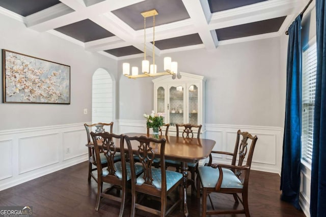 dining room featuring crown molding, dark wood-type flooring, beamed ceiling, and a chandelier