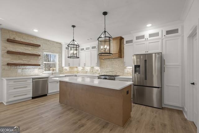 kitchen with white cabinetry, glass insert cabinets, stainless steel appliances, and light countertops