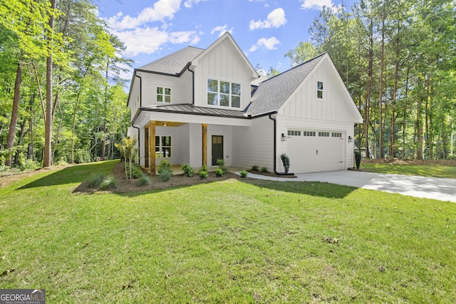 modern inspired farmhouse with a porch, a front yard, and a garage