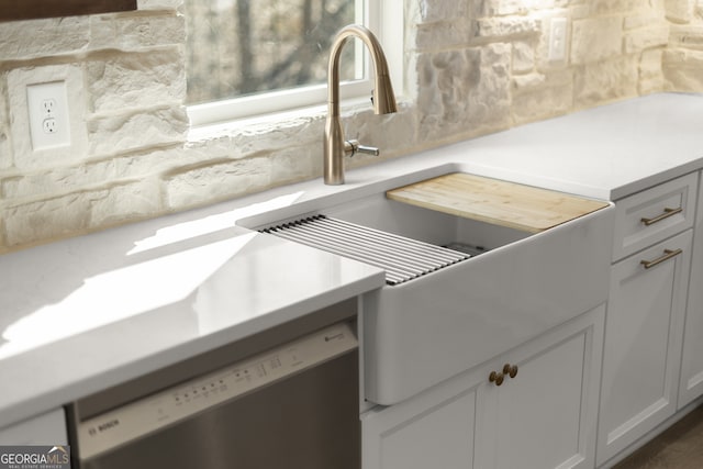 details featuring backsplash, light countertops, and dishwasher