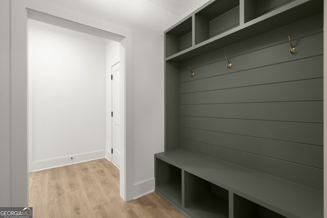 mudroom with light wood finished floors and baseboards