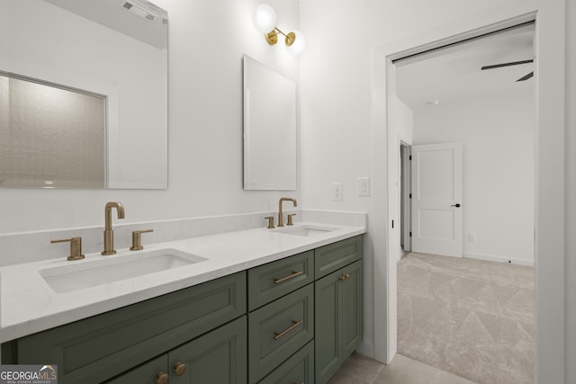 bathroom with double vanity, baseboards, visible vents, and a sink