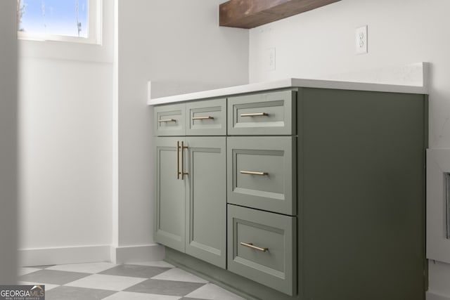 interior details featuring baseboards and tile patterned floors