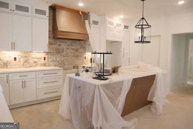 kitchen featuring glass insert cabinets, light countertops, white cabinetry, and premium range hood