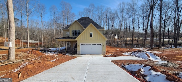 view of snow covered exterior featuring board and batten siding, a standing seam roof, driveway, and metal roof