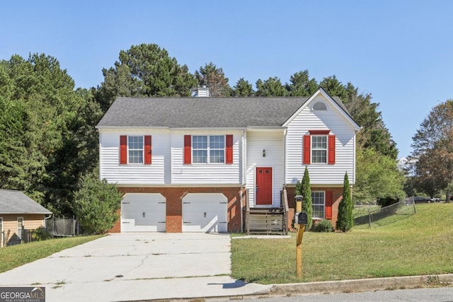 bi-level home with a front lawn and a garage