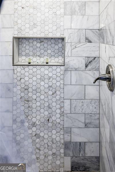 bathroom with a tile shower