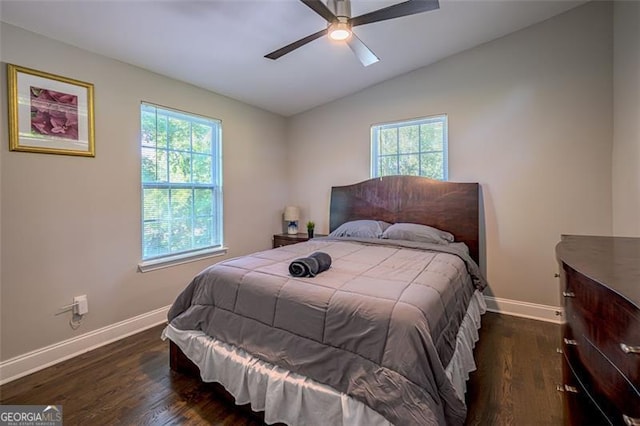 bedroom with ceiling fan, dark hardwood / wood-style floors, vaulted ceiling, and multiple windows