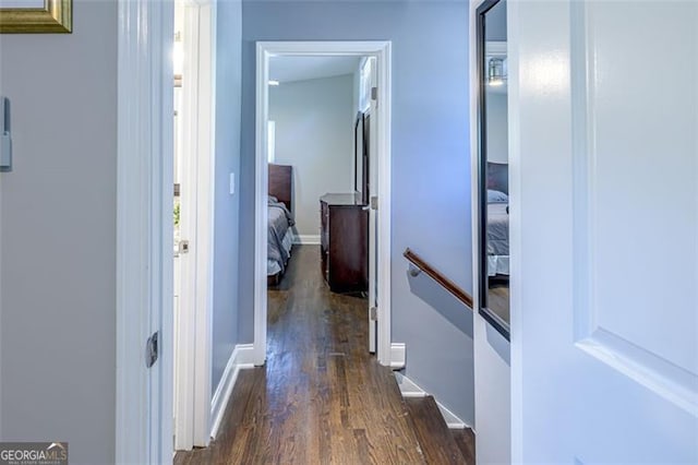 corridor with dark hardwood / wood-style flooring