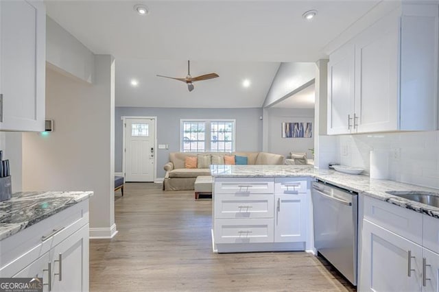 kitchen featuring ceiling fan, dishwasher, light stone countertops, kitchen peninsula, and white cabinets