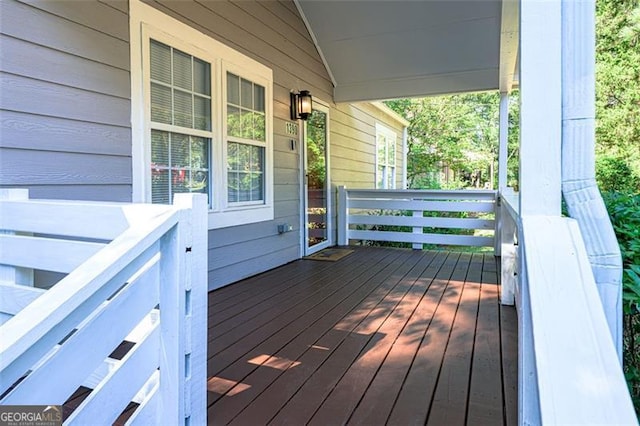 wooden terrace featuring covered porch