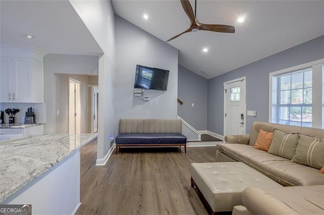 living room featuring light wood-type flooring, high vaulted ceiling, and ceiling fan