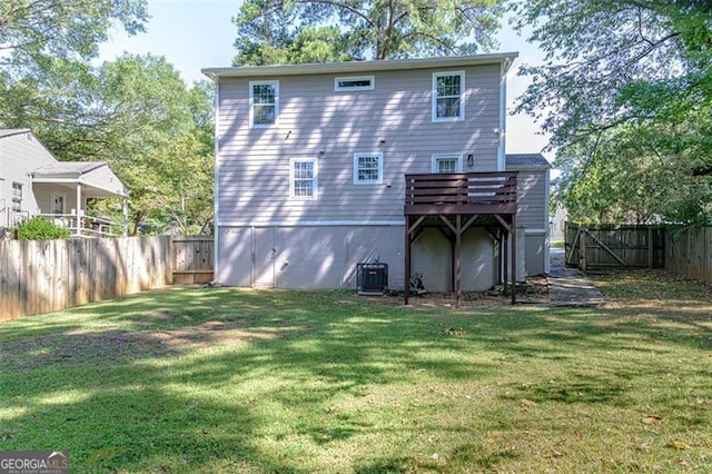 back of property featuring a lawn, central AC, and a wooden deck