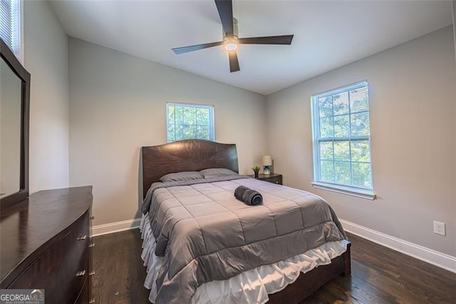 bedroom with ceiling fan, dark hardwood / wood-style flooring, and vaulted ceiling